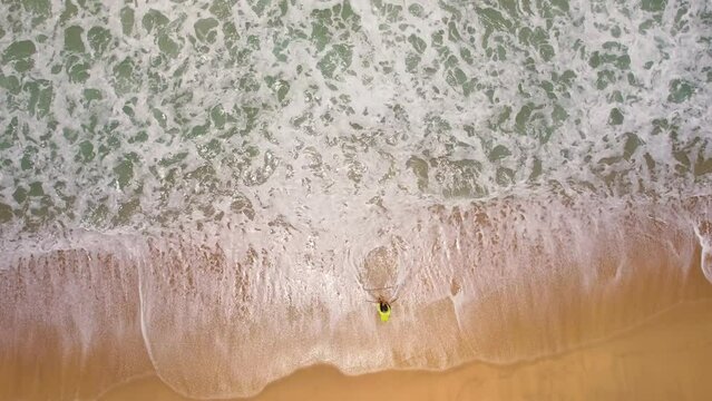 Aerial view top down of Local southern Thai fisherman uses his handmade fish trap and cicada sea on a beach in Phuket Thailand