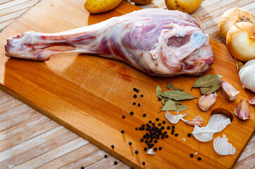 Raw lamb leg with natural ingredients before cooking, nobody