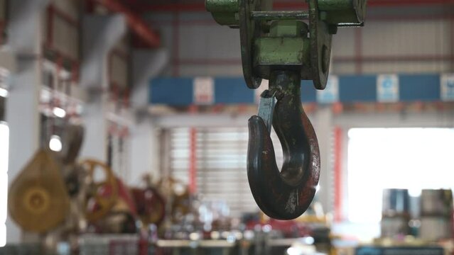 Closeup of swivel chain hook crane of electric hoist in factory workshop, pullersSwivel chain hook equipment for pullers, industry lifting machine