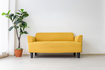White living room interior with modern yellow fabric sofa with empty white wall background
