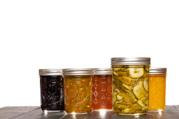 Preserved Pickle Slices Relish Fruit Jams and Jelly in Glass Canning Jars White Background