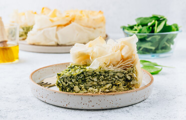 Vegetarian spinach pie with feta cheese on white background. Traditional Greek spinach pie Spanakopita