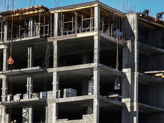 Building under construction. Kazakhstan (Ust-Kamenogorsk). Residential building. Construction crane. Cranes and building. New residential area. Construction site. Concrete frame. Monolith