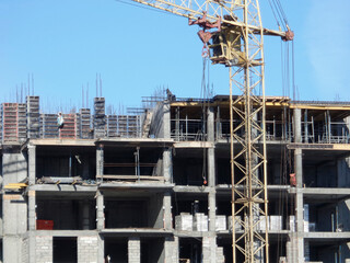 Building under construction. Kazakhstan (Ust-Kamenogorsk). Residential building. Construction crane. Cranes and building. New residential area. Construction site. Concrete frame. Monolith