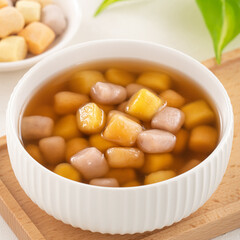 Delicious sweet taro ball soup in a white bowl for serving.