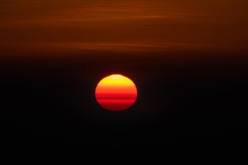 A beautiful sunrise picture with sun appearing as a yolk in the sky.