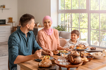 Muslim family having breakfast together. Celebration of Eid al-Fitr