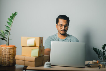 online selling concept Businessmen or SME entrepreneurs pack products according to customer orders...