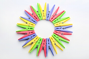 Frame made of plastic clothes pins on light background