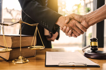 Businessman shaking hands to seal a deal with his partner lawyers or attorneys discussing a contract agreement. - obrazy, fototapety, plakaty