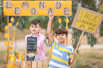 Cute children selling lemonade in park - obrazy, fototapety, plakaty