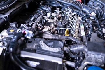 Fototapeta premium Engine car service mechanic maintenance inspection service maintenance car Check engine oil level car in garage showroom dealership blurred background.