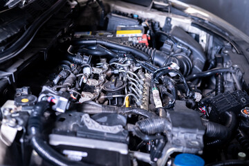 Engine car service mechanic maintenance inspection service maintenance car Check engine oil level car in garage showroom dealership blurred background.
