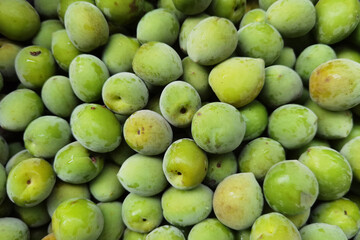 close up of green plum fruits for background 