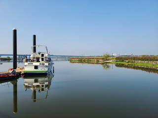 A yacht anchored by a beautiful river.


