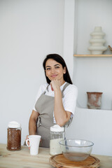 Young brunette woman cooking in kitchen