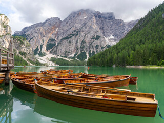 Amazing view of the famous Braies Lake in Italy. Typical rowing boats made of wood. Alpine lake....
