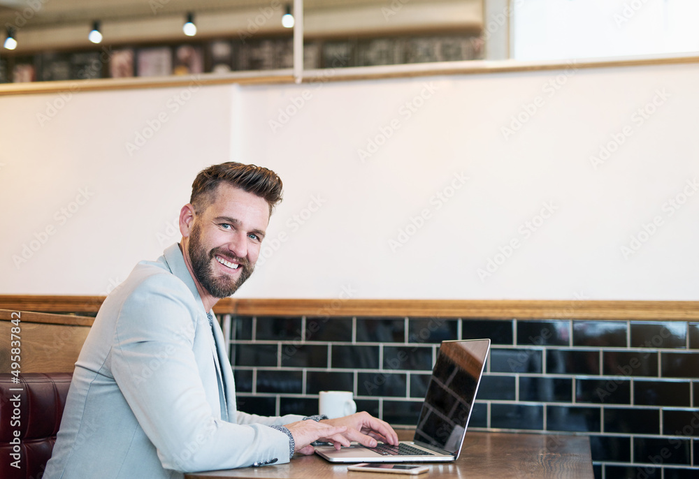 Poster its a great place to get a little work done. cropped portrait of a modern businessman using his lapt