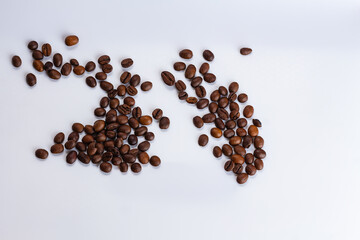 pile of coffee beans on white background with copy space, space for text, selective focus