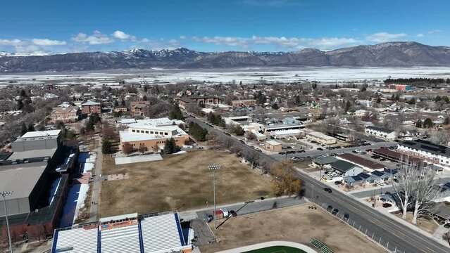 Aerial Snow College Ephraim Utah football field sports pull. Rural college university in Ephraim central Utah. Education, learning, sports and technical study. Late winter early spring weather and cli