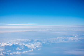 Naklejka na ściany i meble 飛行機から見た青く澄んだ空と雲