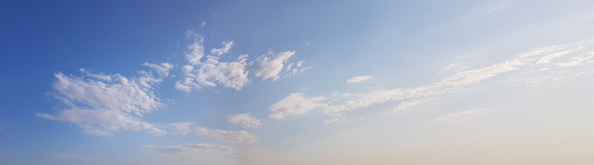 Panorama of blue sky background with white clouds on a sunny day