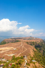 small remote village on mountain top flat bed with bright sky at morning from top angle