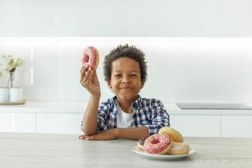 Little boy eating donut