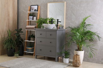 Modern bathroom interior with stylish vessel sink and beautiful green houseplants