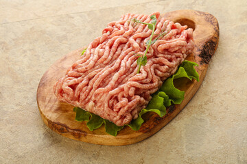 Raw minced pork meat over board
