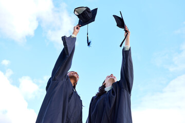 Sometimes youve just gotta take your hat off. Low angle shot of two attractive young female...