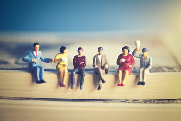 紙幣に座るミニチュアの男女