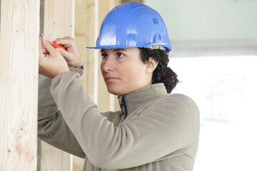 concentrated handywoman holding wooden boards