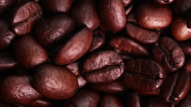 Coffee beans falling down on coffee beans in slowmotion