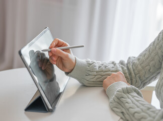 female artist using smart stylus for drawing picture on tablet touch screen device, working home....