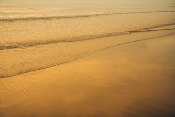 Closeup soft wave of the sea on the sandy beach.