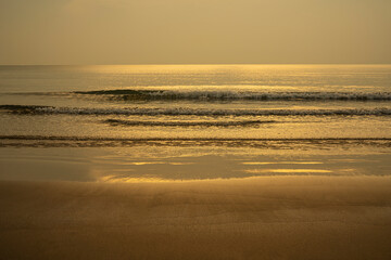 Closeup soft wave of the sea on the sandy beach.