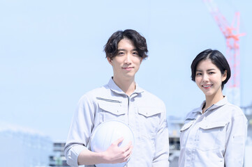 Two people in work clothes looking at the camera