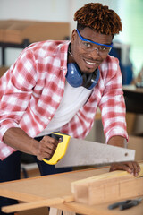 skilled carpenter cutting wood in his woodwork workshop