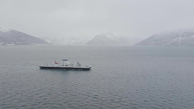 Ferry boat cruises through fog from Olderdalen to Lyngseidet Norway.
