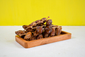 Dried dates fruit on wooden plate for ifthar ramadhan and ied fitr