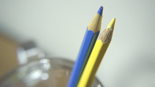 Blue and yellow colored pencils in pencil holder. Blue and yellow are colors of Ukraine national flag.