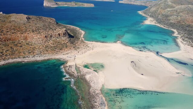 AERIAL: Beautiful white sand beach with turquoise water. Sunny summer day. Paradise. Crete, Greece
