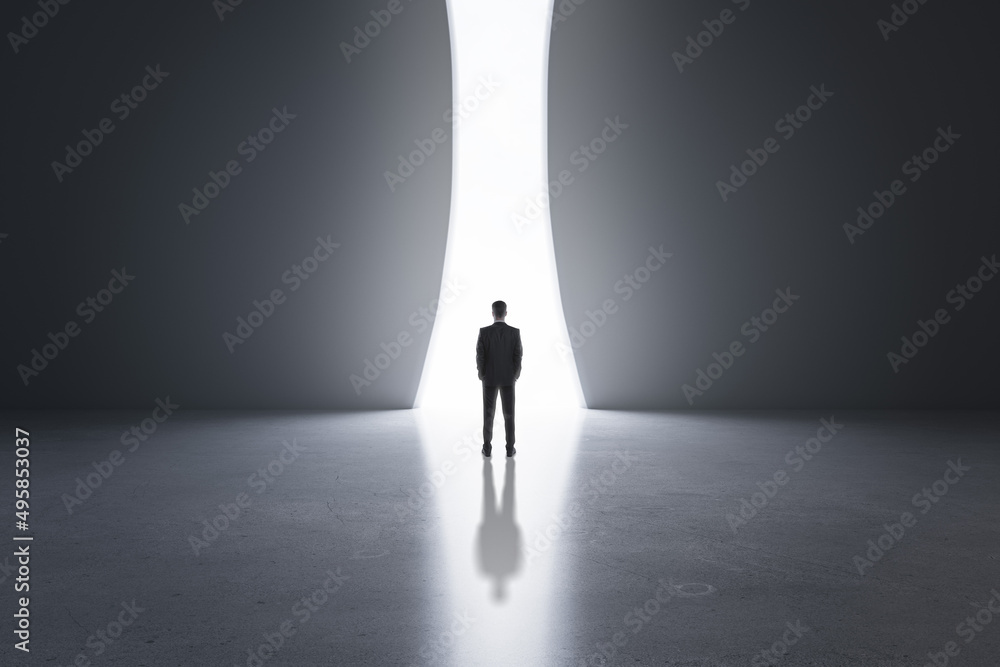 Aufkleber back view of young business man in concrete interior with bright opening window and mock up place on