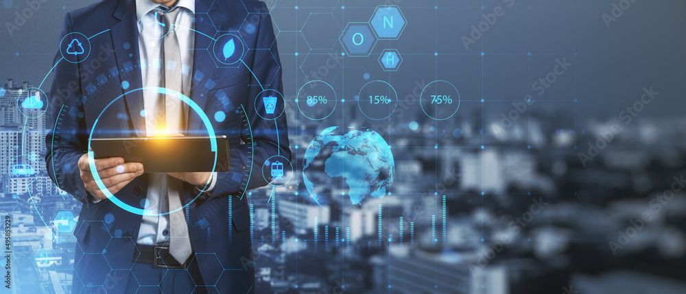 Poster close up of businessman hand using tablet with creative glowing eco hud screen hologram on blurry ci