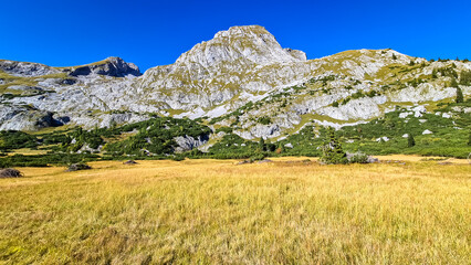 Fototapeta premium Panoramic view on the mountain peaks of the Hochschwab Region in Upper Styria, Austria. Sharp summits of Seemauer, Polster, Oehler in the Alps in Europe. Climbing, Wilderness. Concept freedom