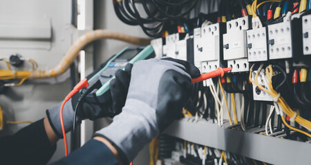 Electrician engineer tests electrical installations and wires on