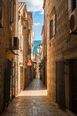 Fototapeta premium Old Town Budva, Montenegro. The first mention of this city - more than 26 centuries ago. We see ancient houses, a very narrow street, cafes, shops.