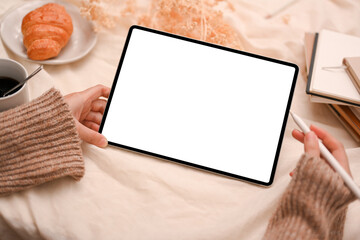 Young woman using digital tablet touchpad, reading something on website