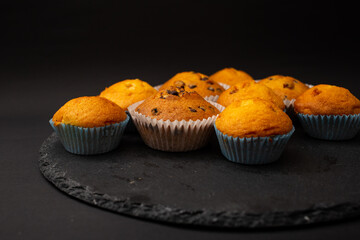 Juicy cupcakes on a black background, confectionery, bakery